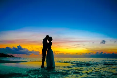 Мужчина и женщина, стоящие на берегу моря · Бесплатные стоковые фото